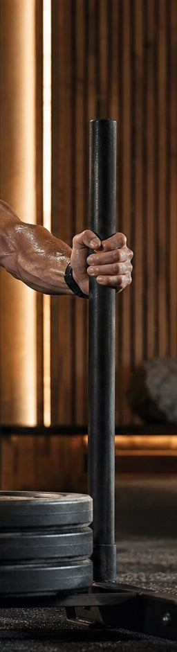 Male strength athlete pushing a weighted sled