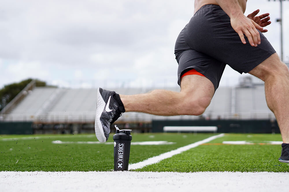 An athlete running on a field beside an XWERKS shaker
